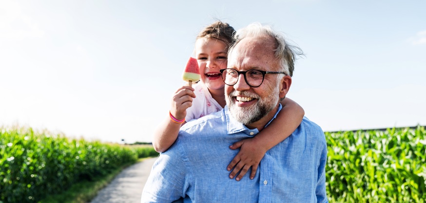 Sustainability Report Cover Image Grandfather Holding Grandchild