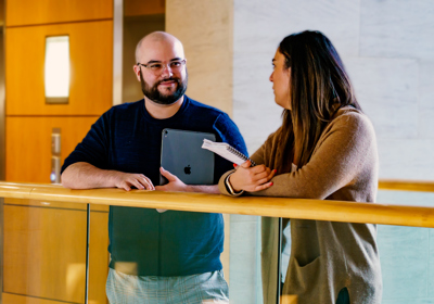 Two People Talking In A Corridor At Work