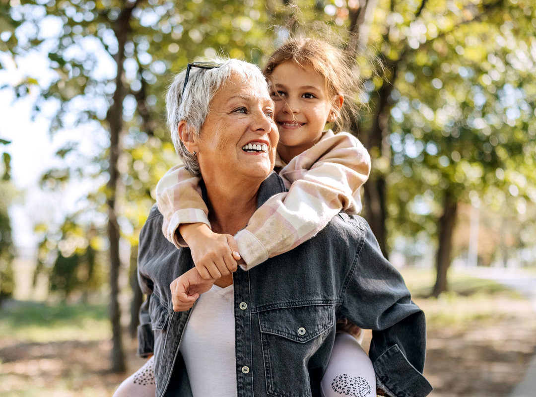 Woman giving child piggy back