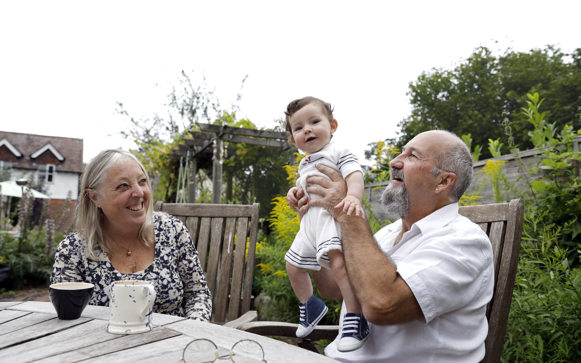 Woman and man holding a baby